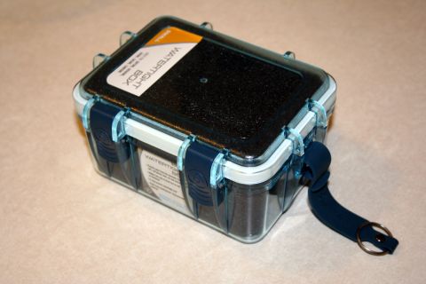 1984 Ford Bronco - A watertight box with blue latches and a black textured lid is shown from a three-quarter angle.