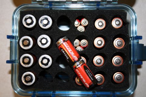 1984 Ford Bronco - Case filled with batteries, some labeled Titanium CR123A.