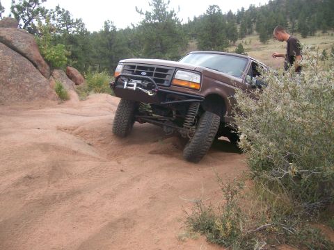 1993 Ford Bronco - This 1992 Ford Bronco is shown tackling a challenging off-road trail with a winch mounted on its custom front bumper.