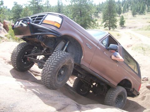1993 Ford Bronco - This lifted 1993 Ford Bronco tackles a challenging off-road course with its suspension flexed.