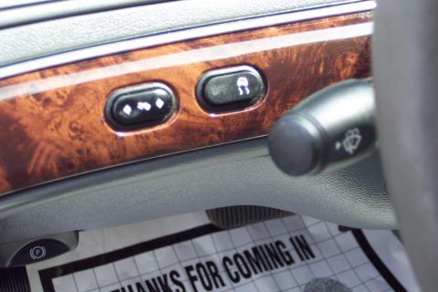 2001 Ford Crown Victoria - Car interior showing dashboard controls and a floor mat with text.