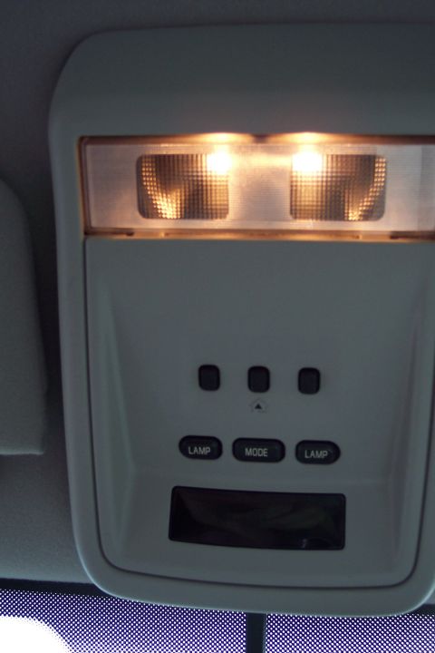 2001 Ford Crown Victoria - The interior overhead console features illuminated lights and control buttons for lamps and mode settings.