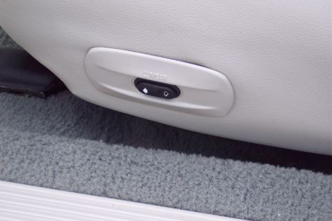 2001 Ford Crown Victoria - Close-up of a car seat's lumbar support control panel.