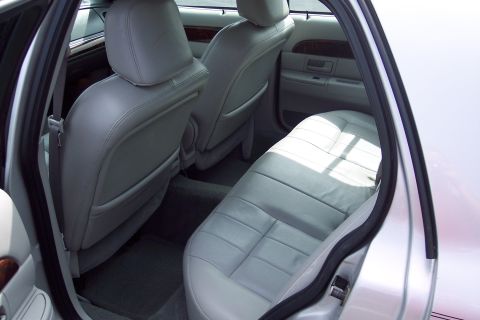 2001 Ford Crown Victoria - Interior view of the back seat area of a silver sedan.