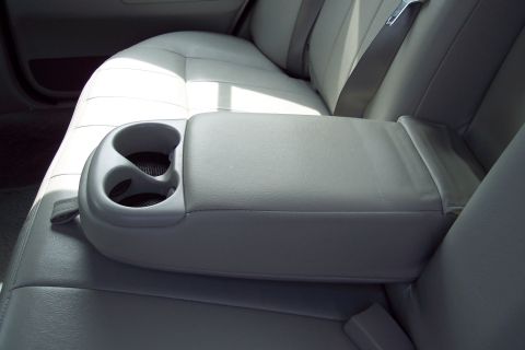 2001 Ford Crown Victoria - Interior view of a car's rear seats and center console with cup holders.