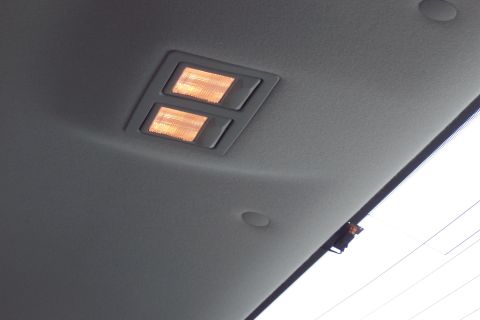 2001 Ford Crown Victoria - The interior dome lights are illuminated on the gray headliner of the vehicle.