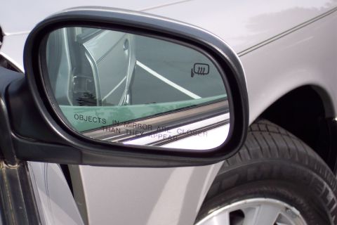 2001 Ford Crown Victoria - Side mirror of a silver 2001 Ford Crown Victoria shows a reflection of the interior and exterior.