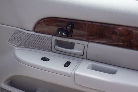 2001 Ford Crown Victoria - The interior door panel shows wood trim and power controls, indicative of a 2004 Grand Marquis.
