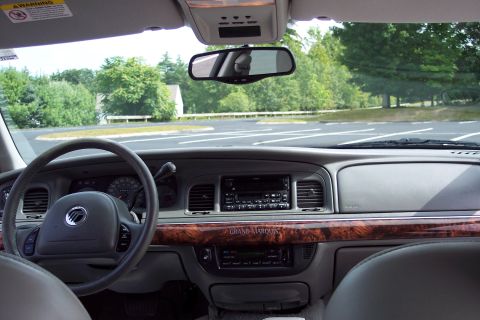 2001 Ford Crown Victoria - The interior dashboard features wood grain trim and the "GRAND MARQUIS" nameplate.