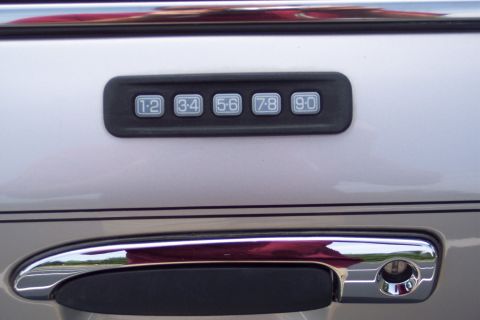 2001 Ford Crown Victoria - Close-up of a car's door handle and the integrated keypad entry system.