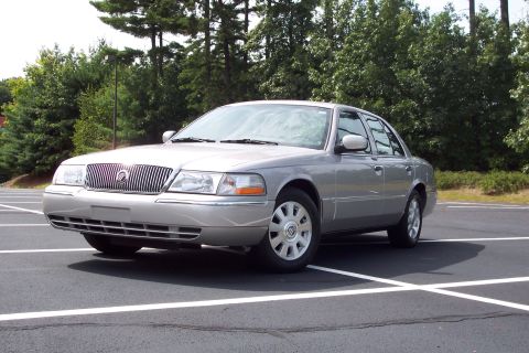 2001 Ford Crown Victoria - This silver 2004 Mercury Grand Marquis is shown from a 3q front angle in a parking lot.