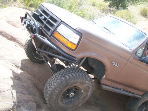 1993 Ford Bronco - This Ford Bronco is navigating a rocky trail, its off-road capabilities.