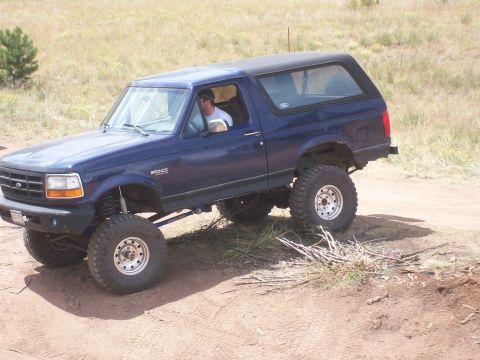 1993 Ford Bronco - This lifted blue Ford Bronco is ready for off-road adventure on a dusty trail.