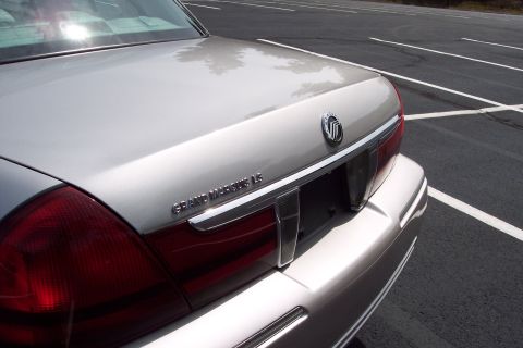 2001 Ford Crown Victoria - Rear view of a silver Mercury Grand Marquis LS, showing its distinctive taillight and chrome accents.