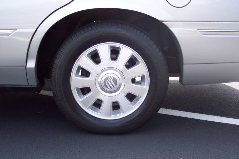 2001 Ford Crown Victoria - Silver Mercury Grand Marquis wheel and fender detail shot.