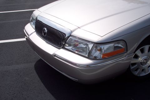 2001 Ford Crown Victoria - The front end of a silver Mercury Grand Marquis is shown parked in a lot.