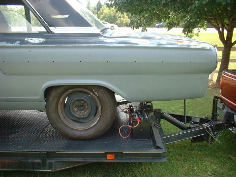 1964 Ford Fairlane - A classic car, likely a 1963 model, is loaded onto a trailer for transport.