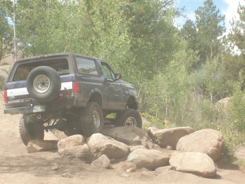 1993 Ford Bronco - This 1993 Ford Bronco tackles a rocky trail, demonstrating its off-road capabilities.