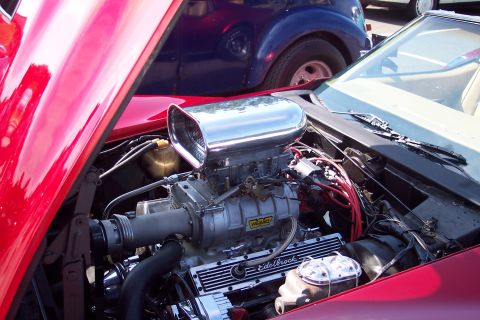 2001 Ford Crown Victoria - Engine bay details of a red car, with a blue car in the background.