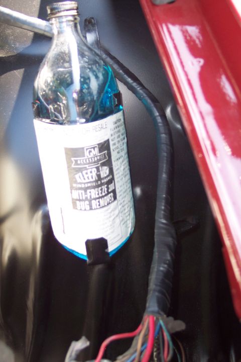 2001 Ford Crown Victoria - Close-up of a GM Accessories Kleer-Flo windshield washer fluid bottle and wiring harness.