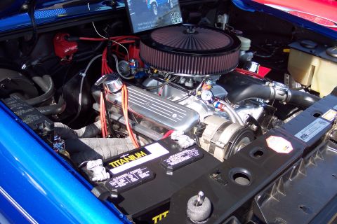 2001 Ford Crown Victoria - Close-up of a modified V8 engine bay, a large air filter and a Titanium battery.
