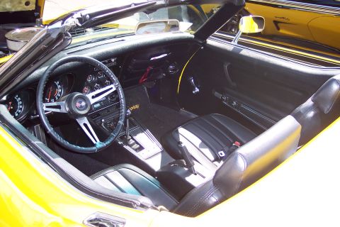 2001 Ford Crown Victoria - The interior of a yellow convertible is shown, with a second yellow vehicle visible in the reflection.