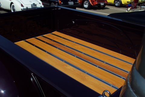 2001 Ford Crown Victoria - A close-up view of a truck bed a wooden plank floor with metal accents.