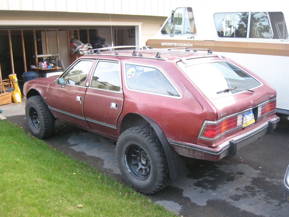 AMC Eagle wagon, lifted with large off-road tires, parked in driveway