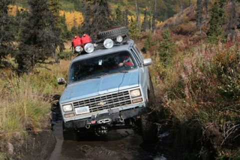 1990 Chevrolet Suburban - This 1990 Chevrolet Suburban tackles a muddy trail with extra gear mounted on the roof.