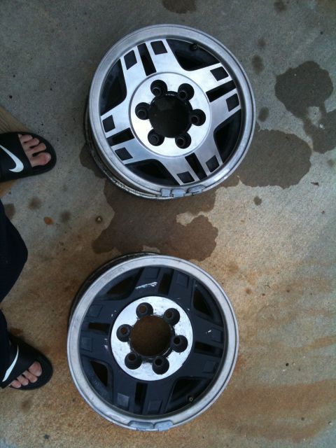 1993 Toyota 4Runner - Two alloy wheels are shown laid out on a concrete surface.