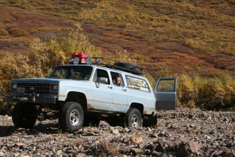 1990 Chevrolet Suburban - This modified SUV is equipped for off-road adventures, with a jerry can and spare tire on the roof rack.