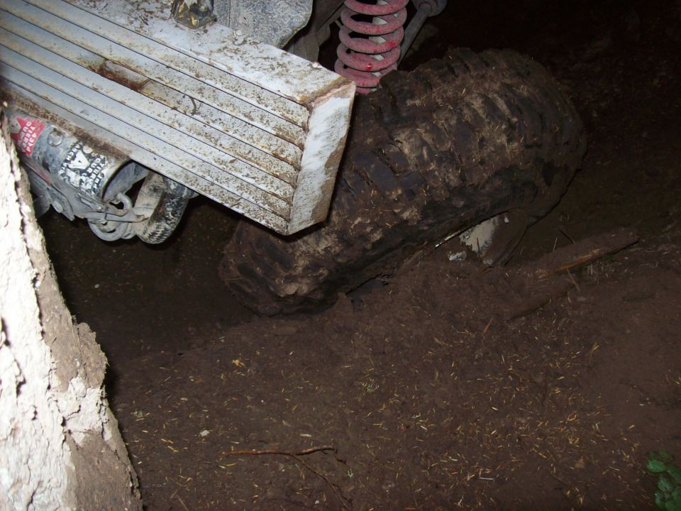 1985 Toyota Pickup/SR5's rear leaf spring suspension and muddy tire are visible from the side