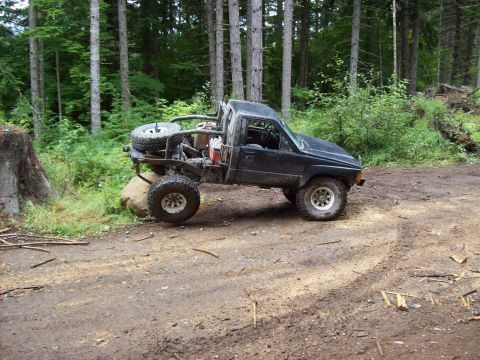 1985 Toyota Pickup/SR5 - This heavily modified pickup truck is equipped for off-road adventures, large tires and a roll cage.