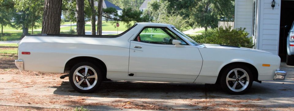 White 1976 Ford Ranchero parked on a dirt driveway