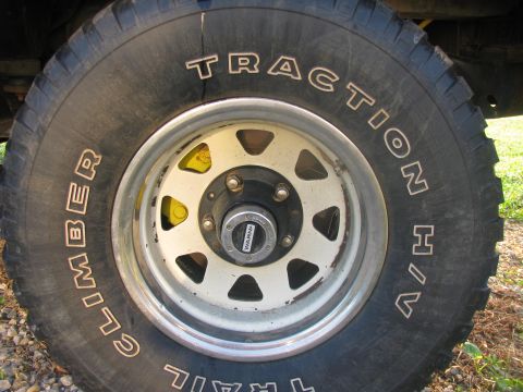 1979 Ford Bronco - A close-up view of an off-road tire and wheel assembly, showing tire tread and wheel details.