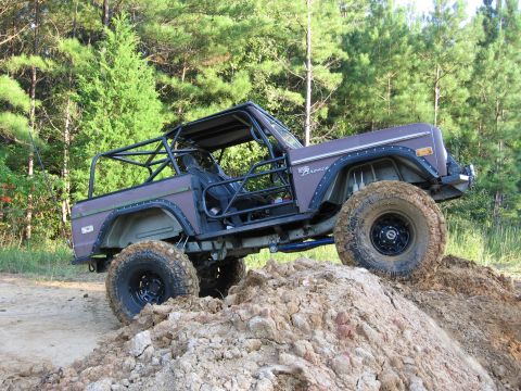 1967 Ford Mustang - This modified off-road vehicle navigates a challenging dirt terrain.