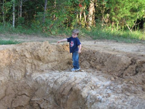 1967 Ford Mustang - A young boy stands on a mound of dirt, exploring the outdoors.
