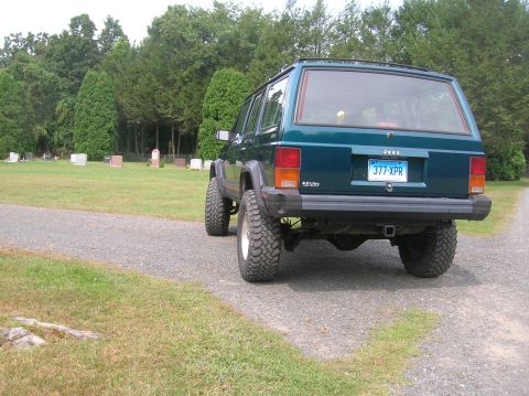 1995 Jeep Cherokee - A green Jeep Cherokee is parked on a gravel road in a cemetery.