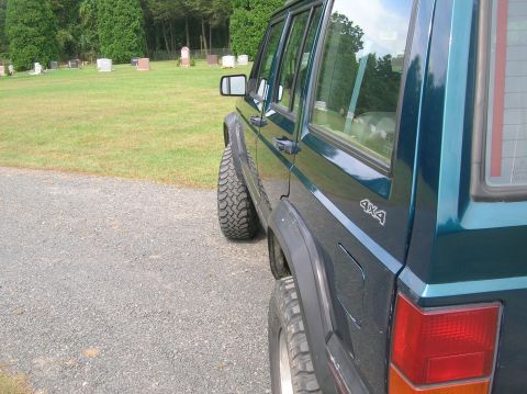 1995 Jeep Cherokee - This 1995 Jeep Cherokee is viewed from the side, its 4x4 decal and tires.