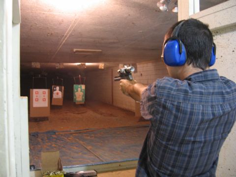 2001 Ford F-150 - Man fires handgun at targets in an indoor shooting range.