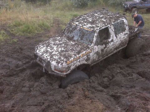1992 Ford F-350 - This 1992 Ford F-350 is stuck in thick mud, with another truck in the background.