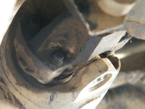 1982 Ford Bronco - Close-up view of a vehicle's driveshaft universal joint, showing mechanical components.