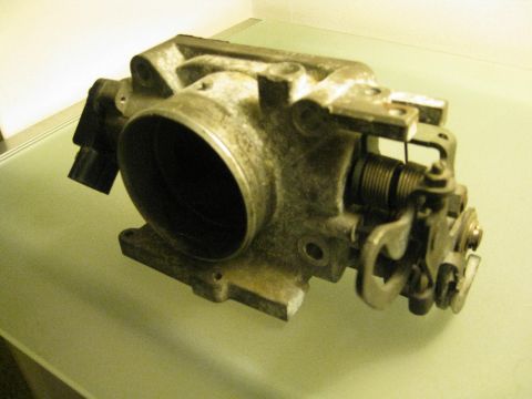 1994 Ford Probe - This is a throttle body, a component of an internal combustion engine.