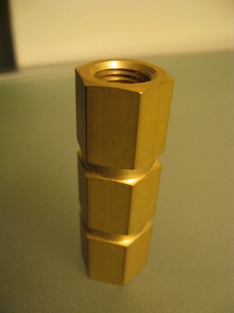 1994 Ford Probe - Close-up of stacked brass fittings with threaded interiors.