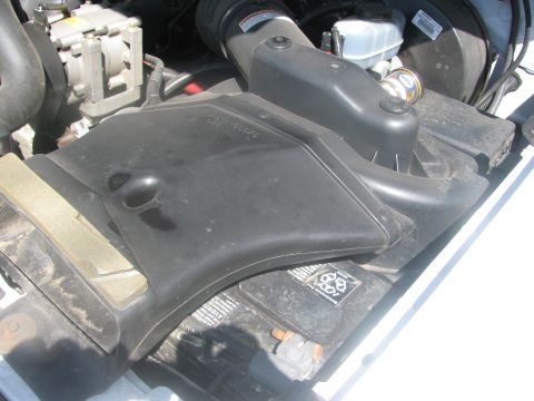 1996 Ford C-350 (Centurion Conversions) - Close-up of the engine bay, focusing on the air intake system and battery.
