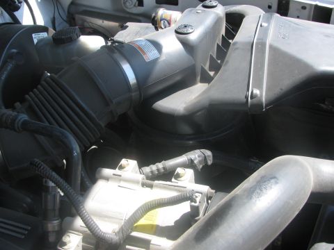 1996 Ford C-350 (Centurion Conversions) - Close-up view of an engine's air intake system components.