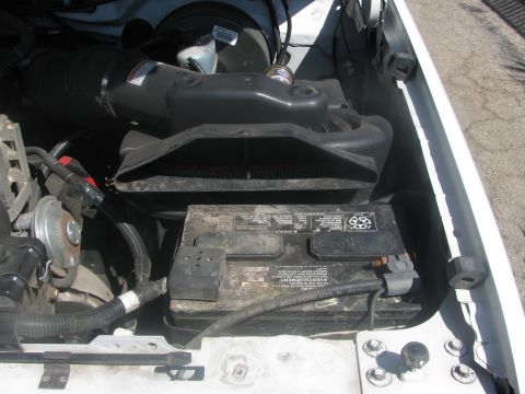 1996 Ford C-350 (Centurion Conversions) - The engine bay shows a battery and air intake system. Text on the battery indicates it is an assembly for Ford U.S.A.