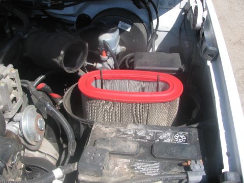 1996 Ford C-350 (Centurion Conversions) - Close-up view of an engine bay, showing the air filter, battery, and brake fluid reservoir.