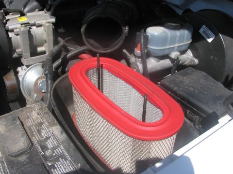 1996 Ford C-350 (Centurion Conversions) - Close-up of an engine bay, focusing on the air filter and intake system components.