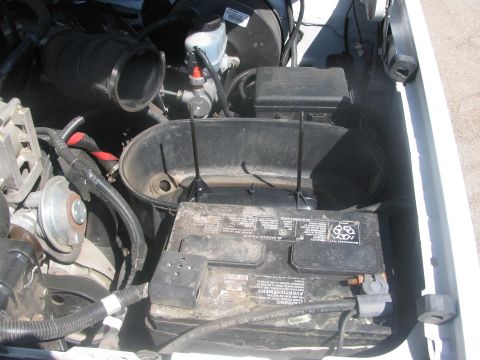 1996 Ford C-350 (Centurion Conversions) - Close-up view of a vehicle's engine bay, focusing on the battery and associated components.